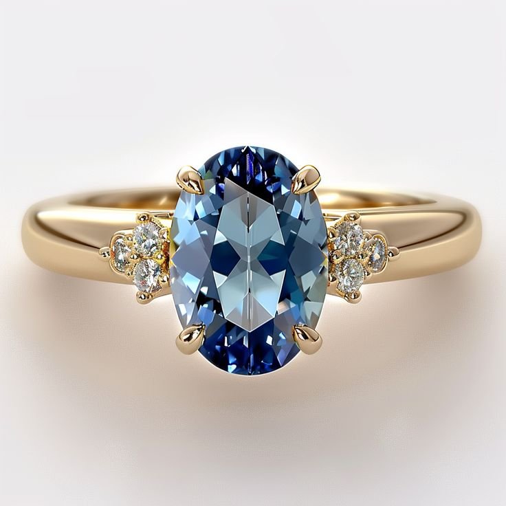 Ring with an oval blue stone flanked by small clear stone clusters on a gold-toned band